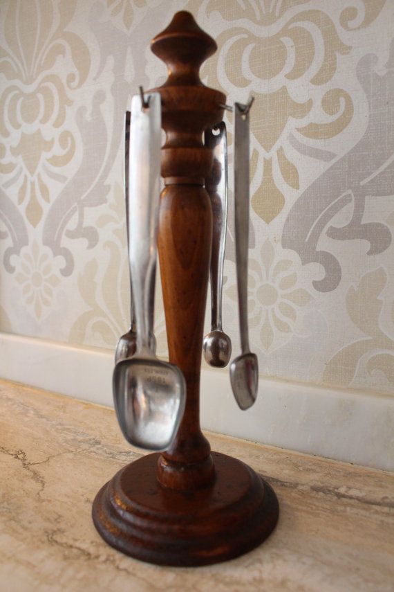 an old fashioned kitchen utensil holder with spoons