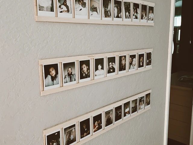 a wall with multiple pictures hanging on it