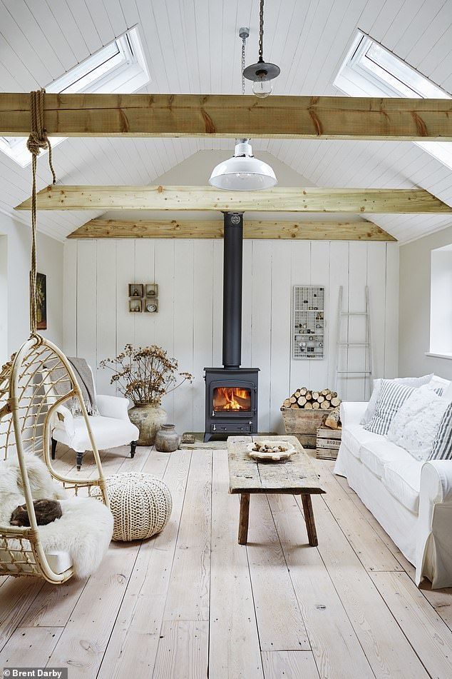 a living room filled with furniture and a fire place in the middle of it's walls