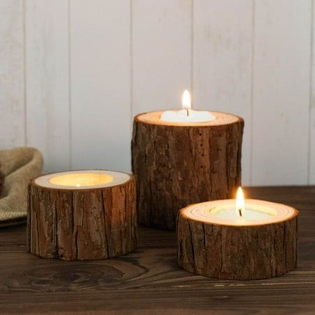 three wooden candles sitting on top of a table