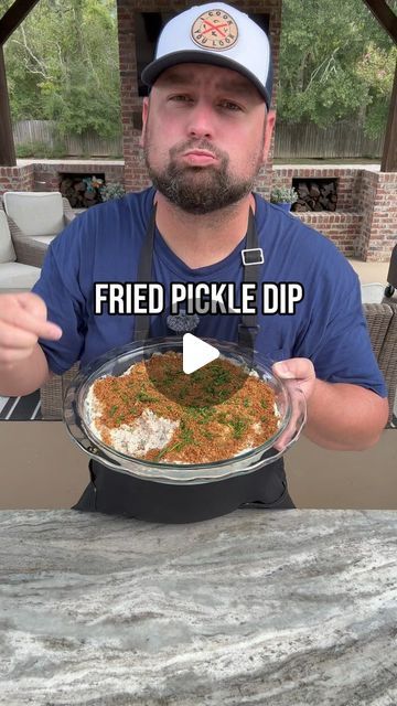 a man holding a plate with food on it and the caption reads fried pickle dip