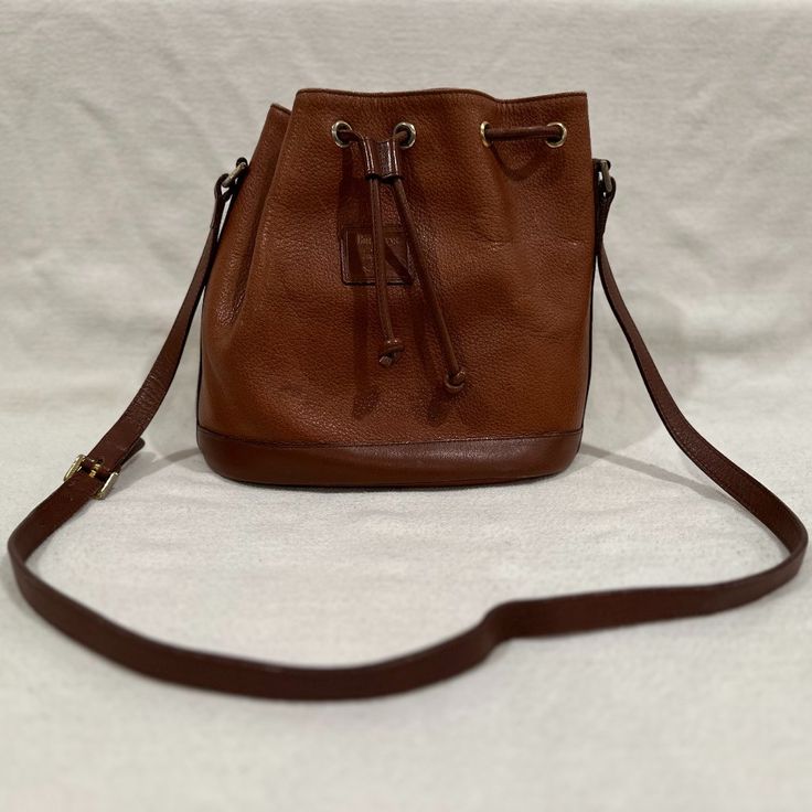 Burberry Leather Bucket Bag, Crossbody. Measurements Are: 9/5" High X 10" Wide X 4.75" Deep. The Strap Is A 19.5" Drop, And Is Adjustable. Classic Burberry Plaid Lining. There Is Some Wear On The Outside As Pictured. The Inside Is Extremely Clean And Has 2 Small Pockets. Burberry Plaid, Leather Bucket Bag, Burberry Bag, Bucket Bag, Burberry, Bag Lady, Plaid, Leather, Women Shopping