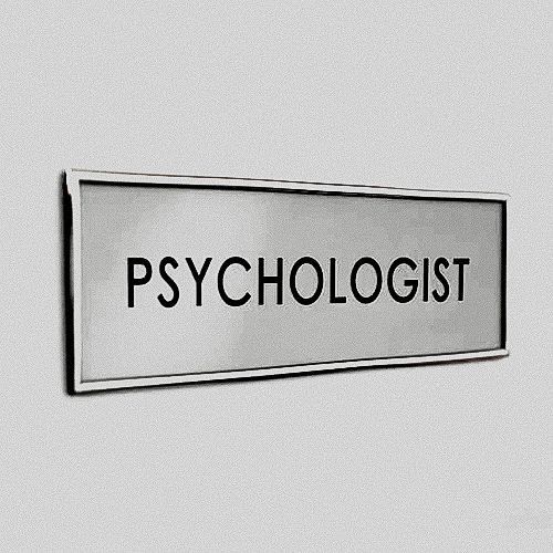 a sign that says psychologist on it in black and white letters, against a gray background