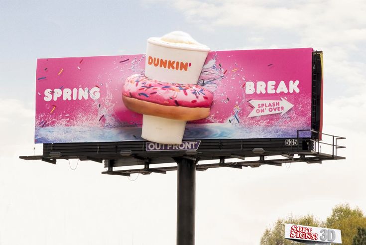 a giant dunkin donut advertisement on the side of a building