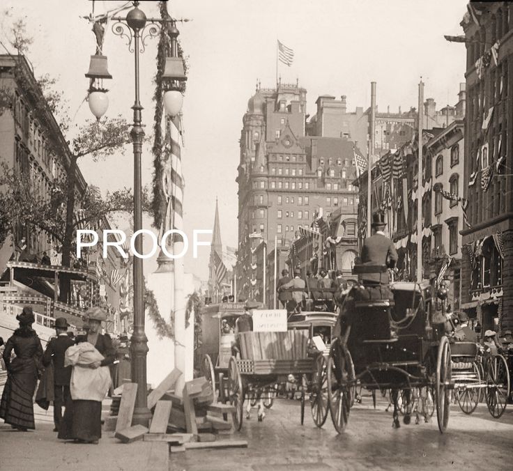 an old black and white photo of people on a city street with horse drawn carriages