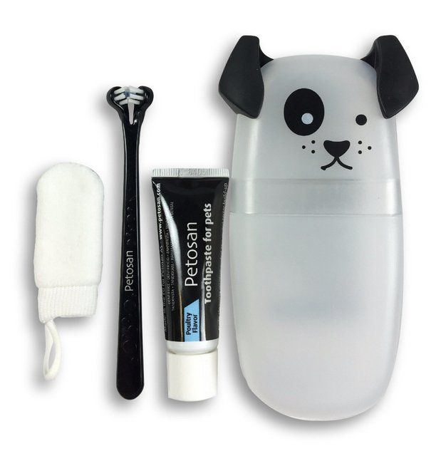 an animal toothbrush holder with two toothpaste tubes and a tooth brush in it