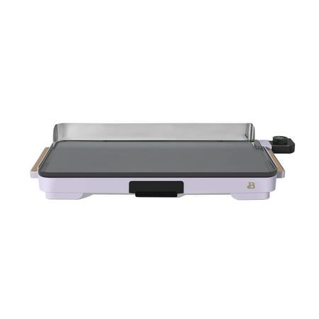 an electric griddle grill with the lid open on a white surface, and black handles