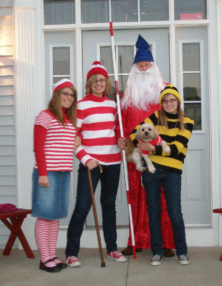 three girls and one boy are dressed up as santa claus