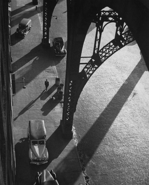 an aerial view of the eiffel tower in paris, france with cars parked under it