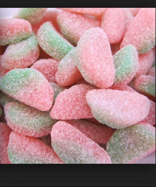 there are many pink and green candy hearts