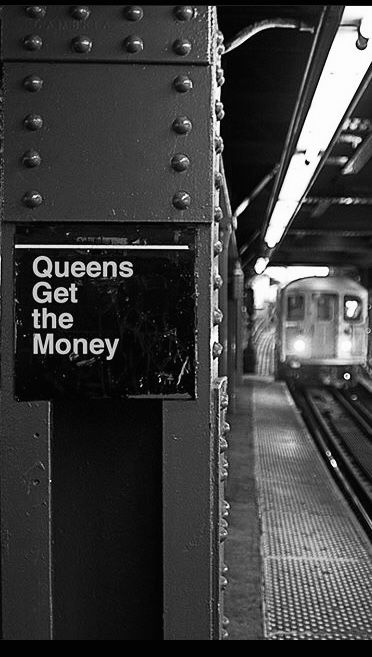 black and white photograph of a subway station with the queen's get the money sign