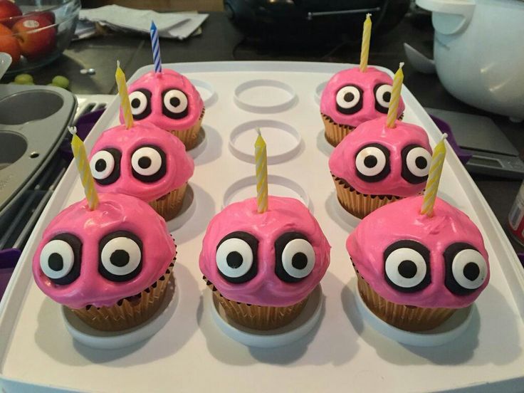 pink cupcakes with googly eyes and candles