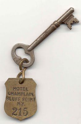 an old key is attached to a hotel charm that says, hotel chappain blue point n y 216