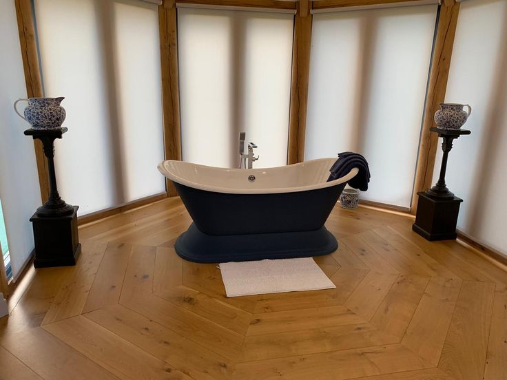 a bath tub sitting on top of a wooden floor