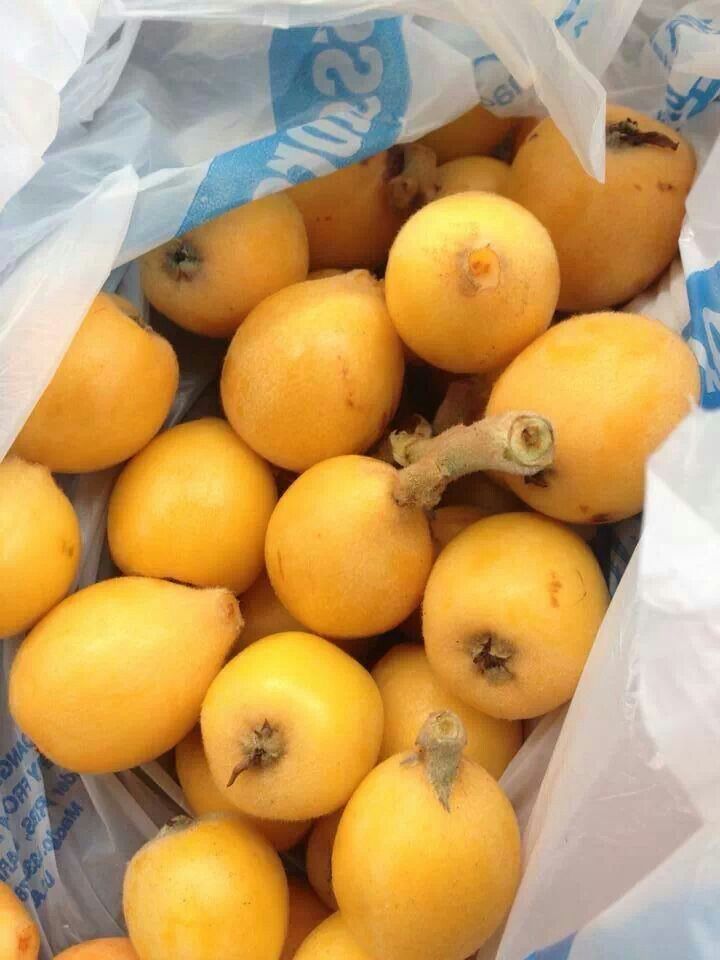 a bunch of yellow fruit sitting inside of a plastic bag