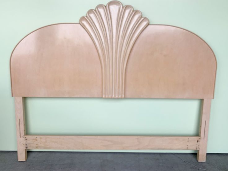 a wooden headboard with an art deco design