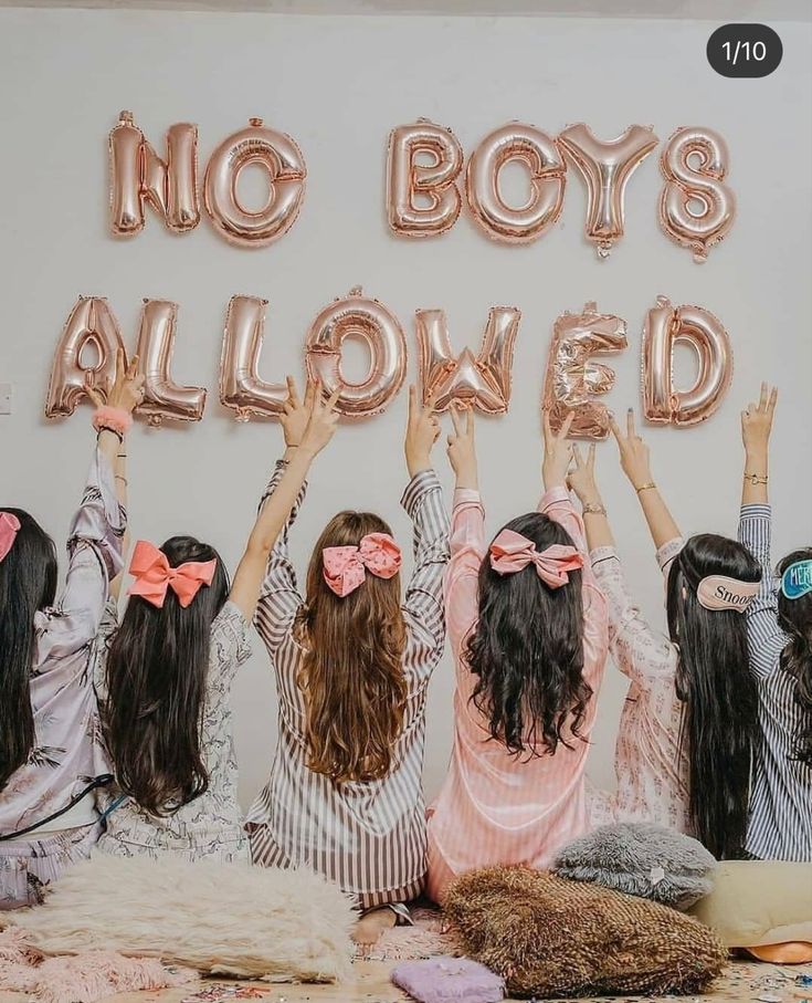 three girls with pink bows are holding up their hands in front of a sign that says no boys allowed