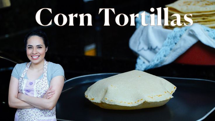 a woman standing in front of a pan with food on it and the words corn tortillas