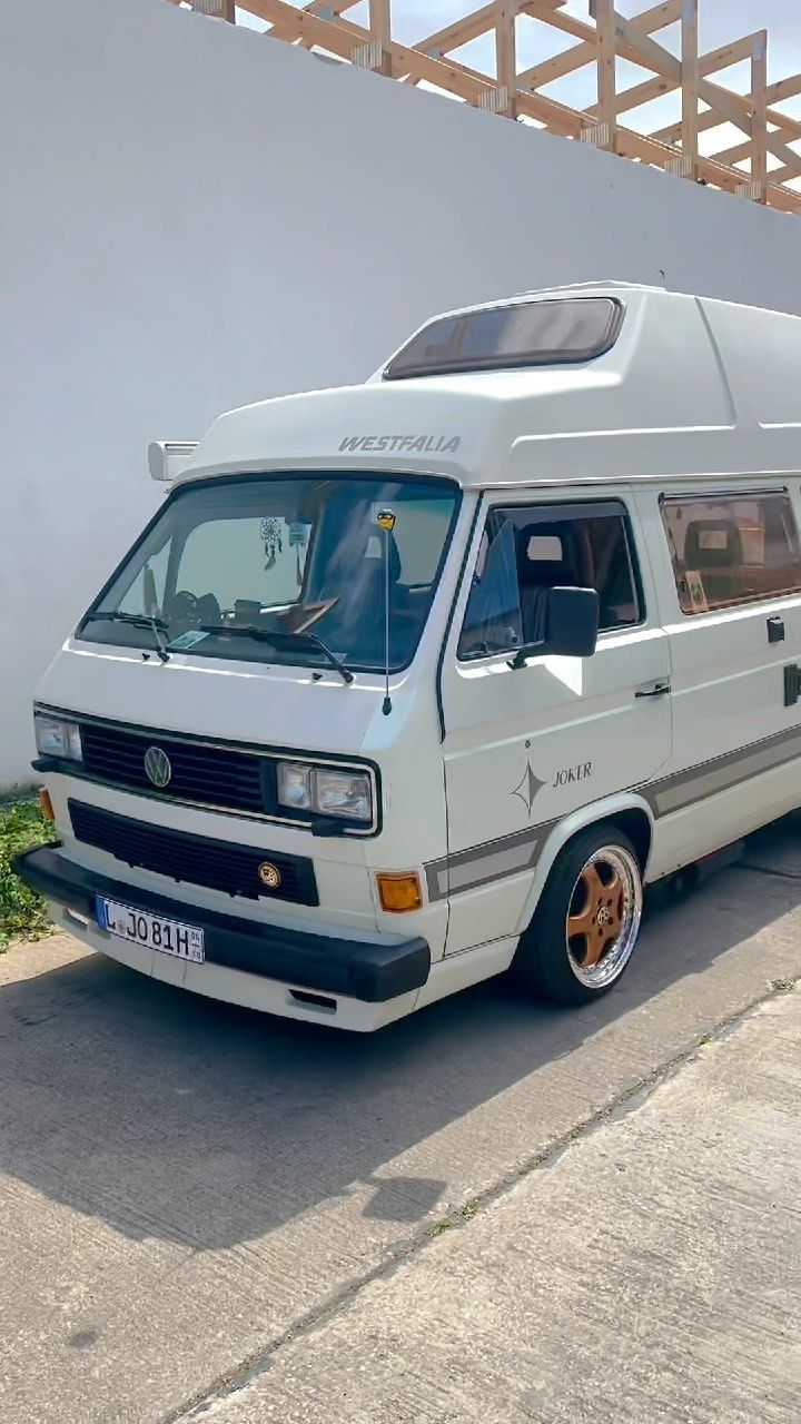 a white van parked in front of a building