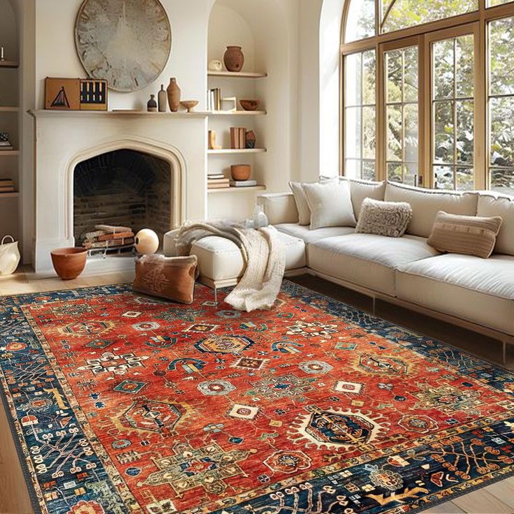 a living room filled with furniture and a large rug on top of a wooden floor