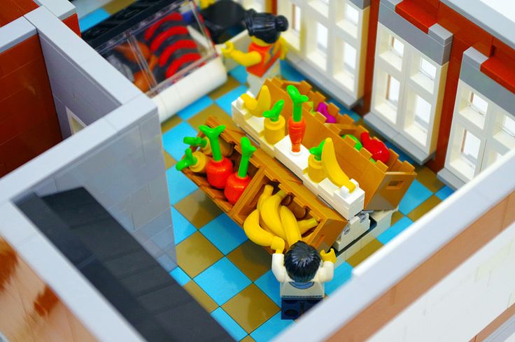 a lego kitchen with bananas, peppers and other foods on the counter top is seen from above