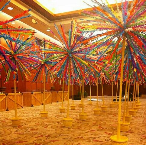 several colorful umbrellas are in the middle of a room