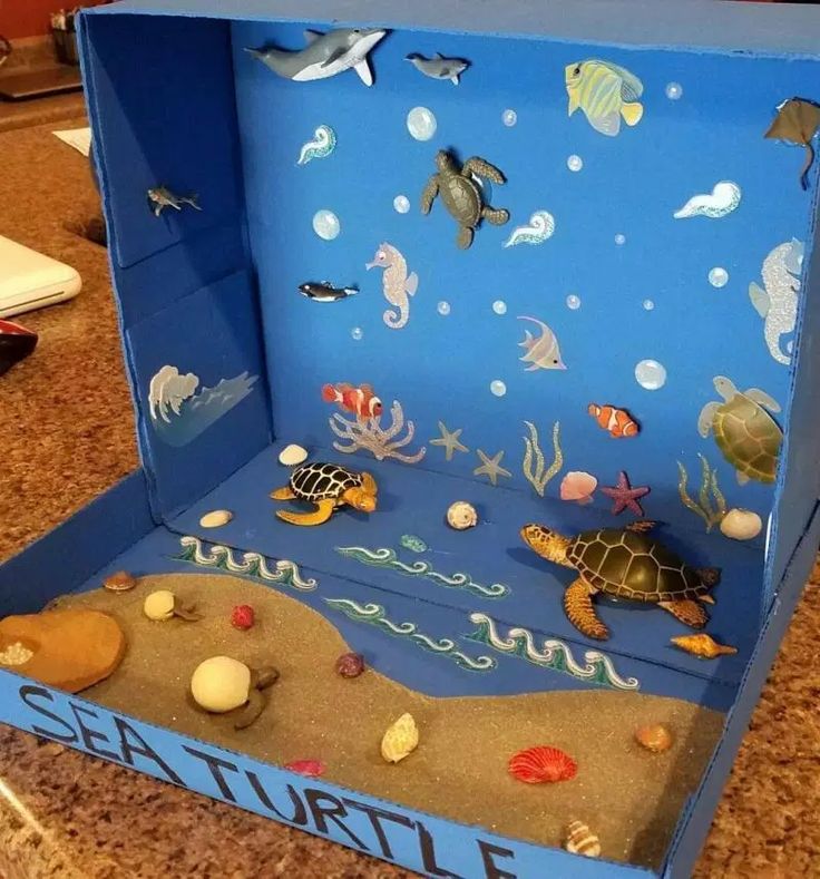 an open cardboard box with sea life on the inside and under it, sitting on a counter