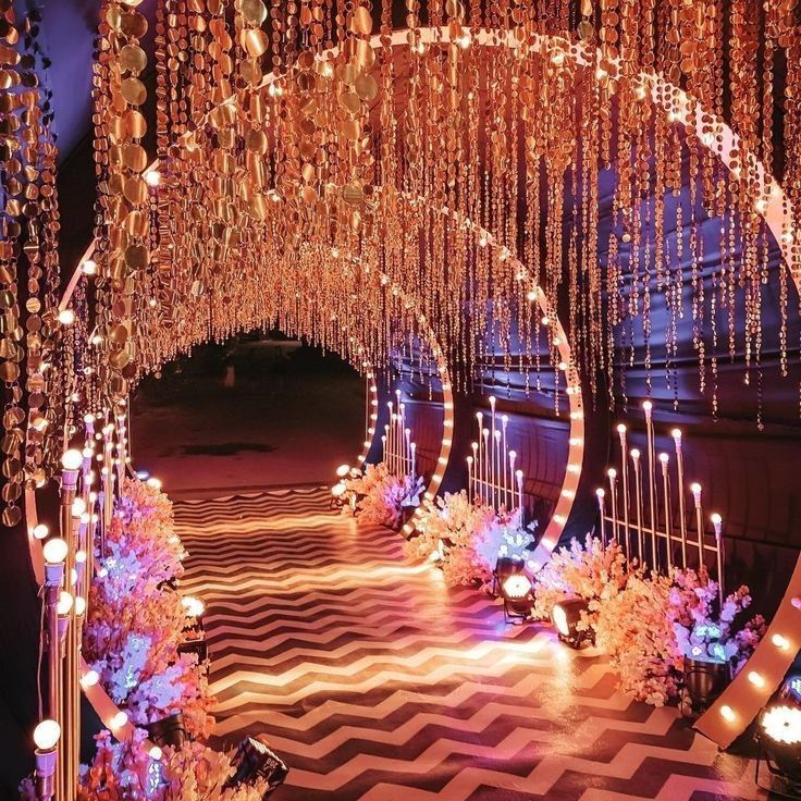 an elaborately decorated stage with candles and chandeliers hanging from it's ceiling