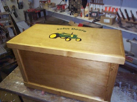 a wooden box sitting on top of a table in a room filled with other items