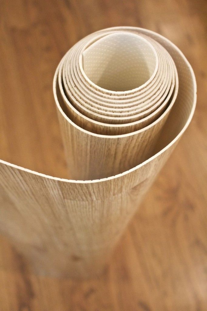 several rolls of white paper sitting on top of a wooden floor next to each other