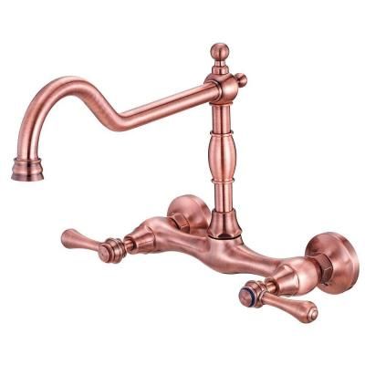 an antique style faucet with two handles and nozzles on the side