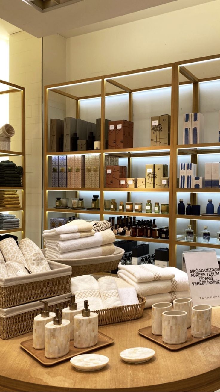 a store display filled with lots of white towels and other items on wooden trays