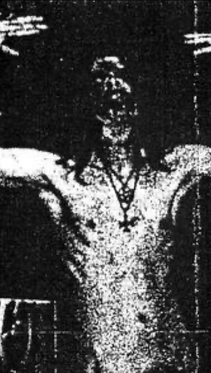 a black and white photo of a man with his arms spread out in front of him