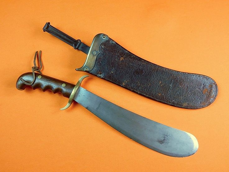 two old knives sitting on top of an orange surface