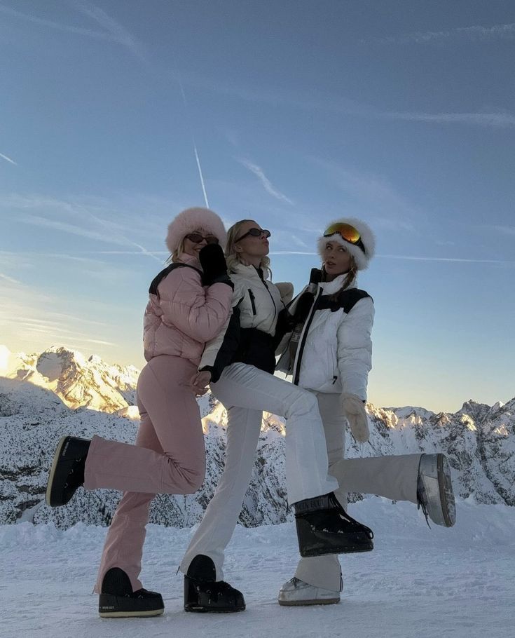 two women walking in the snow with skis on