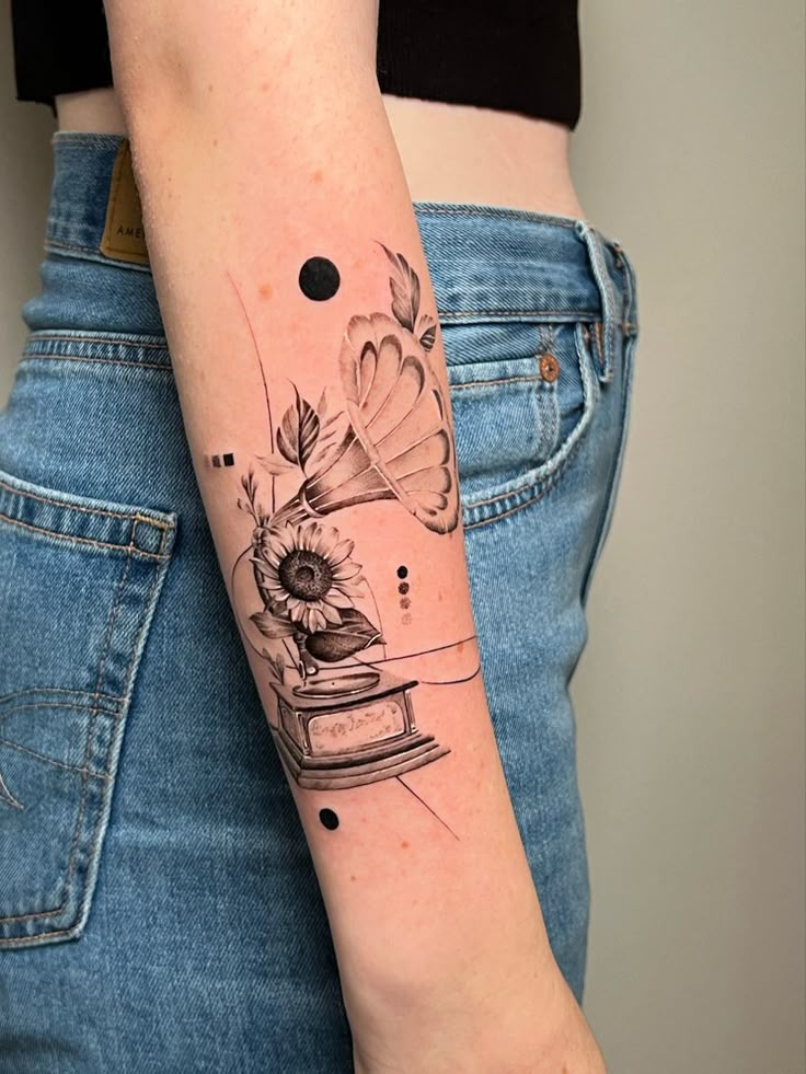 Tattoo, gramophone, record player, flower, hand tattoo, arm tattoo Music Based Tattoos, Sunflower Music Tattoo, Music Flower Tattoo, Rock Music Tattoo, Phonograph Tattoo, Vinyl Record Tattoo, Music Inspired Tattoos, Record Tattoo, Record Player Tattoo