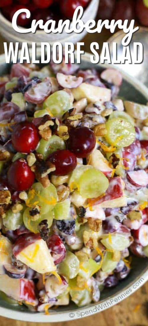 cranberry walnut salad in a bowl with grapes and pecans on the side