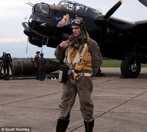 a man standing in front of an airplane