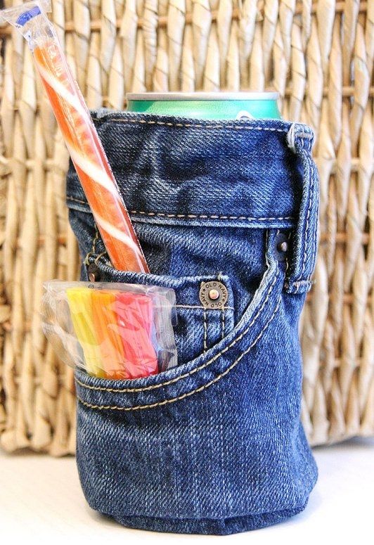 a straw sticking out of the back pocket of someone's blue jean pants with a rainbow colored toothbrush in it