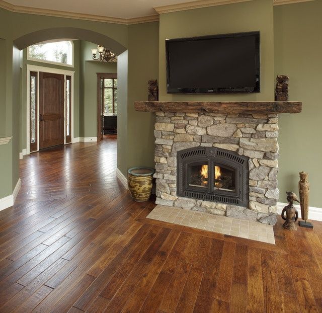 a living room with wood floors and a fireplace