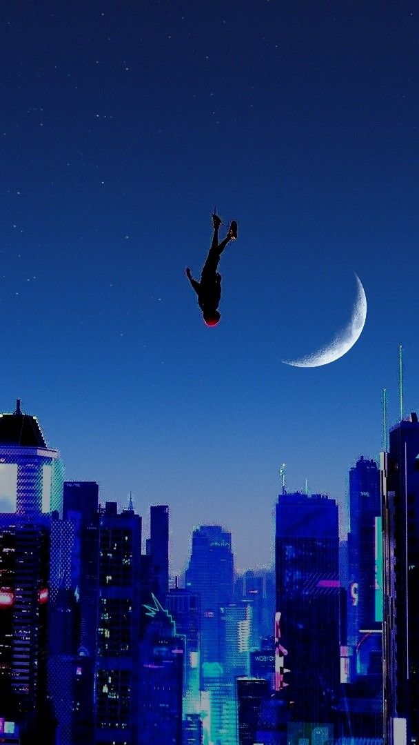 a man flying through the air while riding a skateboard in front of a city skyline