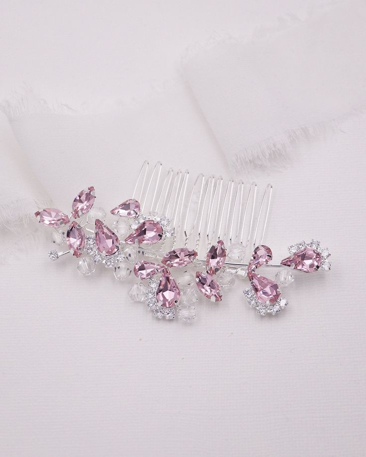 New color This perfectly sized wedding comb features sparkling high quality bicone diamond crystals with accents of pink pear and marquise rhinestones that is the perfect accessory for the bride or any special occasion event.  DETAILS * High quality crystals with pink and clear rhinestones.  * Measures 3 inches wide and 1 1/4 inches tall. * Perfect for a side or back comb accessory for the bride, mother of the bride, parties, or any special occasion. * Finish: silver, gold or rose gold. SHOP MORE JEWELRY & HAIR ACCESSORIES:  http://www.etsy.com/shop/AllureWeddingJewelry SHIPPING * Leaves our facility within 1-2 business days. * Shipping upgrades include priority mail, UPS ground, two-day and overnight delivery. Wedding Comb, Hair Comb Clips, Gold Shop, Crystal Hair Comb, Bridal Comb, Event Details, Crystal Hair, Crystal Wedding, Pink Rhinestones