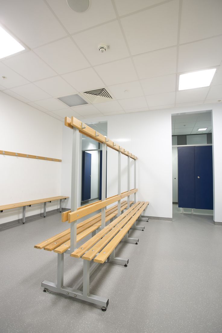 an empty room with benches and lockers