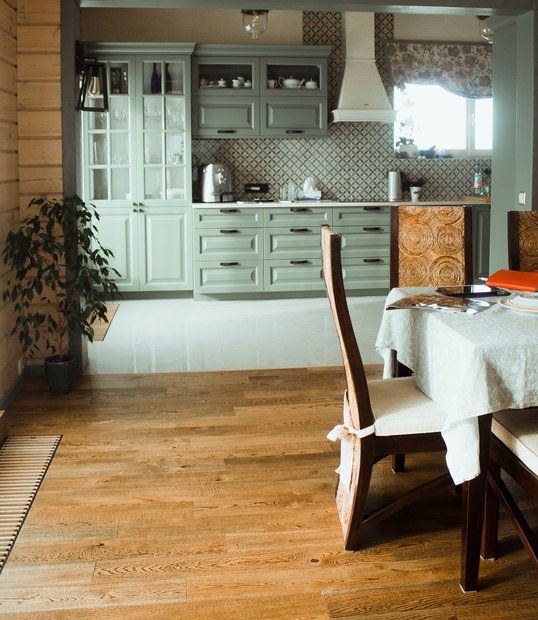 a dining room table with two chairs and a white table cloth on top of it