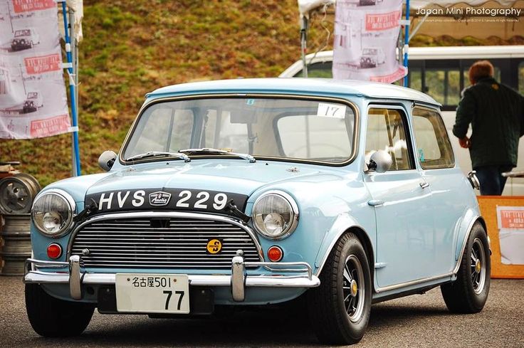 an old blue car is parked on the street