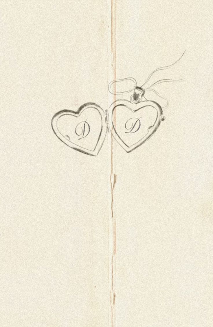 two hearts are drawn on the side of a piece of paper