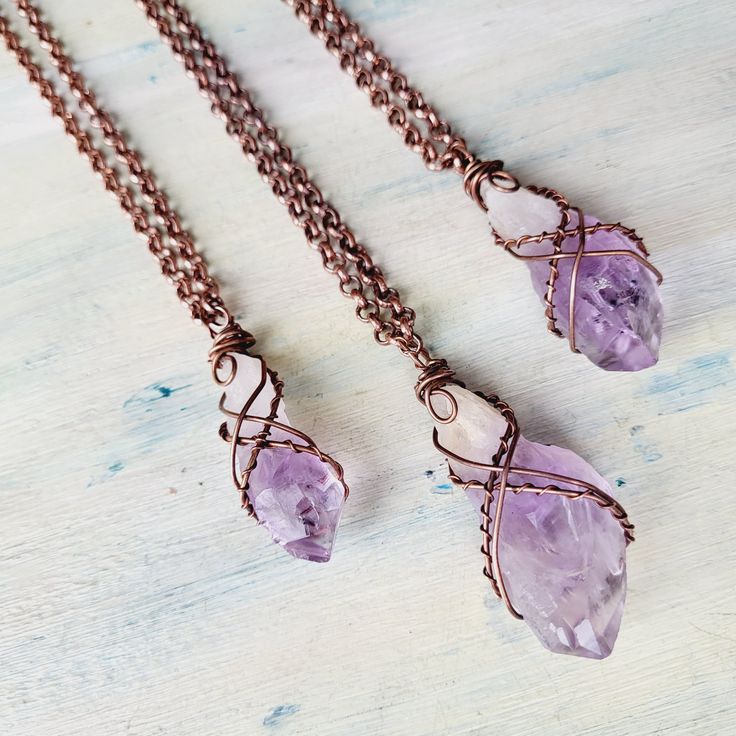 "Raw Amethyst Quartz necklaces. Oxidised Copper Wire wrapped beautiful good quality Amethyst Crystal necklace. Layers great with other necklaces. Love stone necklace. February birthstone. Choose your necklace length with a choice of 16\", 18\", 20\", 22\", 24\", 30\", 32\". These are Raw Natural Gemstones and vary in shape, color and size, each one is unique in its own way. Amethyst is a meditative and calming stone which works in the emotional, spiritual, and physical planes to provide calm, balance, patience, and peace. Amethyst is used as beneficial when dealing with legal problems and money issues, which can lead to prosperity and abundance, though it is not the best known prosperity stone. Emotionally, amethyst is used in crystal healing to help heal personal losses and grief, bringin Handmade Purple Crystal Necklaces, Rough Stone Wire Wrap, Luxury Wire Wrapped Spiritual Jewelry, Luxury Wire Wrapped Healing Jewelry, Amethyst Wire Wrapped Necklace Gift, Electroformed Amethyst Crystal Necklace As Gift, Hand Wrapped Amethyst Crystal Necklace For Gift, Purple Wire Wrapped Copper Wire Necklace, Hand Wrapped Purple Copper Necklace