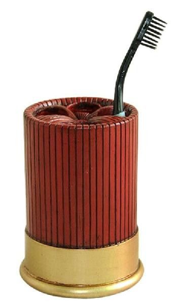 the toothbrush holder is red and gold with a black tooth brush in it's top