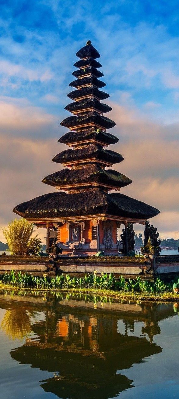 a tall building sitting next to a body of water