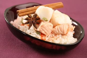 a bowl filled with rice, meat and spices